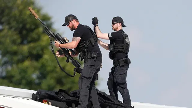 epa11476851 Law enforcement snipers set up before the arrival of former president Trump on a rooftop overlooking a campaign rally at the Butler Farm Show Inc. in Butler, Pennsylvania, USA, 13 July 2024. During the campaign rally Trump was rushed off stage by secret service after a shooting. Former US President Donald Trump stated on social media that a bullet pierced the upper part of his right ear and that a person attending the rally was killed, another was injured and that the alleged shooter was dead. EPA/DAVID MAXWELL