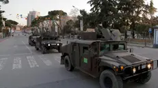 epa08310358 Albanian army vehicles on the main bulevard in Tirana, Albania, 20 March 2020. Albanian authorities have decided to raise the presence of the army in the streets as people still gather in public places and don't respect the red zone hours forbiding to be outside after six pm. Albanian has so far two people dead and 69 infected with Covid-19 coronavirus. Countries around the world are taking increased measures to stem the widespread of the SARS-CoV-2 coronavirus which causes the Covid-19 disease. EPA/MALTON DIBRA