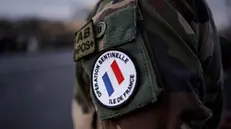 epa08925069 A close up picture of a badge of a French soldier, part of France's anti-terror 'Vigipirate' plan, dubbed 'Operation Sentinelle' is seen as French soldiers, firefighters and members of veterans associations line the street on Pont Alexandre III bridge in Paris, France, 07 January 2021, for the funeral procession of hearses carrying French soldiers sergeant Yvonne Huynh and corporal Loic Risser, who were killed in action during Operation Barkhane in Mali on 02 January 2021. EPA/YOAN VALAT