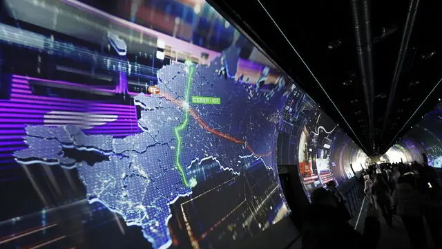 epa10958414 People attend the International Exhibition-forum Russia on the opening day as a screen shows a map displaying Crimea, the self-proclaimed Donetsk and Luhansk People's Republics, Zaporozhye and Kherson, as part of Russian territory, at the All-Russian Exhibition Center (VDNH) in Moscow, Russia, 04 November 2023. The International Exhibition-forum Russia, designed to demonstrate Russian main achievements in technology, science, tourism and culture, runs from 04 November 2023 to 12 April 2024. EPA/MAXIM SHIPENKOV