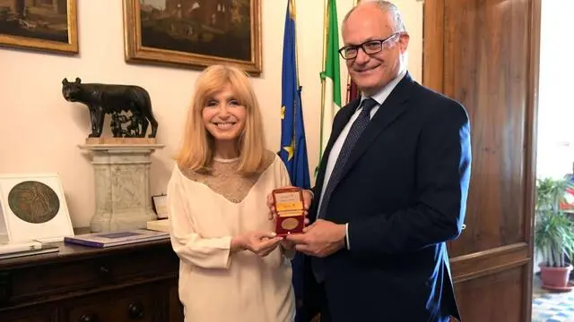 Dori Ghezzi e il sindaco di Roma, Roberto Gualtieri, durante la firma oggi in Campidoglio del protocollo d'intesa tra Roma Capitale e Fondazione Fabrizio De André Onlus che sancisce il ritorno in pianta stabile del 'Premio Fabrizio De André - Parlare musica' nella piazza del quartiere della Magliana che porta il nome del grande cantautore genovese, 18 luglio 2024. NPK ANSA / Ufficio stampa Comune di Roma +++ ANSA PROVIDES ACCESS TO THIS HANDOUT PHOTO TO BE USED SOLELY TO ILLUSTRATE NEWS REPORTING OR COMMENTARY ON THE FACTS OR EVENTS DEPICTED IN THIS IMAGE; NO ARCHIVING; NO LICENSING +++