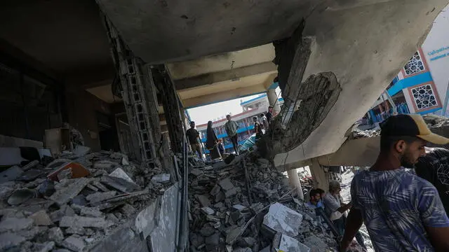 epa11478181 Palestinians inspect a damaged UNRWA school following an Israeli air strike in Al Nuseirat refugee camp, central Gaza Strip, 14 July 2024. At least 12 people were killed following an Israeli air strike in the camp, according to the Palestinian Ministry of Health. The Israeli military stated on 14 July, that the Israeli Air Force (IAF) struck the area of UNRWA's Abu Oraiban School School building in Nuseirat, claiming that the location served as a 'hideout and operational infrastructure' to direct and carry attacks against Israeli troops operating in the Gaza Strip. More than 38,000 Palestinians and over 1,400 Israelis have been killed, according to the Palestinian Health Ministry and the Israel Defense Forces (IDF), since Hamas militants launched an attack against Israel from the Gaza Strip on 07 October 2023, and the Israeli operations in Gaza and the West Bank which followed it. EPA/MOHAMMED SABER