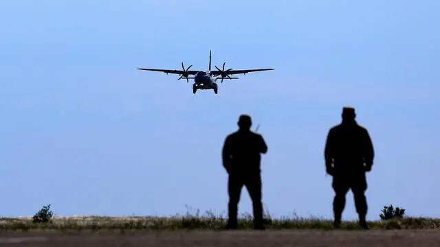 epa11407103 Airport ground personnel look at a second military aircraft containing Przewalski's horses as it prepares to land at Arkalyk airport in the Altyn Dala area in Kazakhstan, 06 June 2024 (issued 13 June 2024). Two CASA army aircrafts carrying a total of eight horses on board took off from airports in Prague and Berlin on 03 June and landed in Arkalyk, Kazakhstan, the following day, as part of the Return of Wild Horses project - a joint effort by the European Association of Zoos and Aquariums (EAZA), the Frankfurt Zoological Society and the Czech Army. The project involves moving Przewalski's horses - extinct in the wild in the late 1960s - back to their native steppes in Kazakhstan's Altyn Dala region in order to save the species, as well as restore fully functioning steppe grassland ecosystems. According to the mission organizers, the Prague Zoo has played a crucial role in preserving the species in captivity so far. The goal of the operation is to return at least 40 horses throughout the next few years and help establish a self-sustaining population in the region. EPA/FILIP SINGER ATTENTION: This Image is part of a PHOTO SET