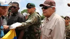 epa11443807 Elected president of Panama, Jose Raul Mulino (R), visits the Lajas Blancas migrant shelter in Darien, Panama, 28 June 2024. Mulino said that he aspires to sign with the United States, within the framework of his assumption of office on 01 July 2024, an agreement for the repatriation of irregular migrants who arrive in the Central American country through the dangerous Darien jungle, the natural border with Colombia. EPA/Moncho Torres