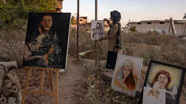 epa11480495 Visual artist Ilham Al-Astal, 28, a displaced Palestinian from Khan Yunis camp, stands among her paintings near her destroyed home, in Khan Yunis, southern Gaza Strip, 15 July 2024. Through art, Ilham depicts the suffering of displaced people, highlighting events and scenes from the ongoing conflict in Gaza. Since 07 October 2023, up to 1.7 million people, or more than 75 percent of the population, have been displaced throughout the Gaza Strip, some more than once, in search of safety, according to the United Nations Relief and Works Agency for Palestine Refugees in the Near East (UNRWA), which added that the Palestinian enclave is 'on the brink of famine', with 1.1 million people (half of its population) 'experiencing catastrophic food insecurity' due to the conflict and restrictions on humanitarian access. EPA/HAITHAM IMAD