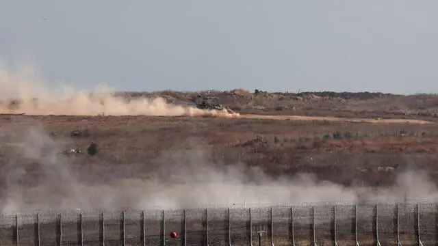 epa11344258 Israeli tanks drive across the security fence with Jabalia in northern part of the Gaza Strip, as seen from the Israeli side of the border on, in southern Israel, on 16 May 2024. More than 35,100 Palestinians and over 1,455 Israelis have been killed, according to the Palestinian Health Ministry and the Israel Defense Forces (IDF), since Hamas militants launched an attack against Israel from the Gaza Strip on 07 October 2023, and the Israeli operations in Gaza and the West Bank which followed it. EPA/ATEF SAFADI