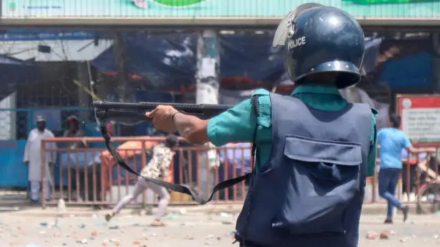 epa11485546 A Police member reacts as demonstrators clash with police, Bangladesh Chhatra League (BCL) and Jubo League members, during ongoing quota students protests under the slogan 'Anti-Discrimination Student Movement' at Mirpur area in Dhaka, Bangladesh, 18 July 2024. According to Police, at least 11 people have been killed and several hundred injured following violent clashes between protesting students and police erupted during nationwide student protests over the abolition of quotas in government jobs. EPA/MONIRUL ALAM