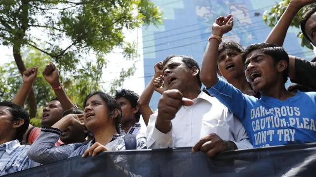 epa04176678 Leaders of garment wokers organizations and workers attend a protest rally demandig the full compensation for the dead and injured workers of the Rana Plaza building collapse in Dhaka, Bangladesh, 23 April 2014. The anniversary of the blaze at the Rana Plaza building, which left over 1,100 workers dead and about 2,500 rescued alive is coming up on 24 April 2013. The Rana Plaza disaster highlighted unsafe conditions for many of the four million workers in the South Asian country's garment industry. EPA/ABIR ABDULLAH