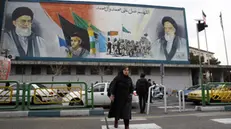 epa11186416 Iranians walk past a wall painting of Iranian Supreme Leader Ayatollah Ali Khamenei (L) and late Supreme Leader Ayatollah Ruhollah Khomeini (R), during the last day of election campaigning in Tehran, Iran, 28 February 2024. Iranians on 01 March 2024 vote for new members of Iran's parliament, and for the Assembly of Experts, the body in charge of appointing Iran's Supreme Leader. EPA/ABEDIN TAHERKENAREH