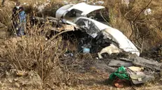 epa10406668 Belongings (R, front) next to the wreckage at the crash site of a Yeti Airlines ATR72 aircraft in Pokhara, central Nepal, 15 January 2023. A Yeti Airlines ATR72 aircraft carrying 72 people on board, 68 passengers and 4 crew members, crashed into a gorge while trying to land at the Pokhara International Airport. According to a statement from the Civil Aviation Authority of Nepal (CAAN), at least 68 people were confirmed dead. EPA/BIJAYA NEUPANE