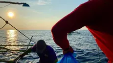 epa11344337 A Filipino volunteer from the civilian-led relief mission â€˜Atin Ito!â€™ (Itâ€™s Ours!) coalition distributes relief goods to fishermen aboard a motorized wooden boat on the waters of the disputed South China sea, on 16 May 2024. A civilian-led mission joined by at least a hundred fishermen embarked on Scarborough Shoal in the disputed South China Sea to assert the Philippines' territorial claim. The Scarborough Shoal, also known as Bajo de Masinloc, is a fishing ground within the Philippine maritime territory that was occupied by the Chinese a decade ago. Recently, there have been reports that Chinese coast guard ships are driving away Filipino fishermen from the area. EPA/FRANCIS R. MALASIG