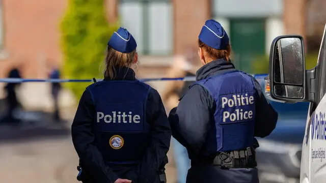 epa11227680 Police officers stand guard near a house where a police officer was killed during an operation in Lodelinsart, Belgium, 18 March 2024. According to Charleroi public prosecutor's office, one police officer died and two others were injured on 18 March as a result of an exchange of fire during a house search on rue de l'Etang. A suspect who had been injured was taken to the hospital, where he died. EPA/OLIVIER MATTHYS