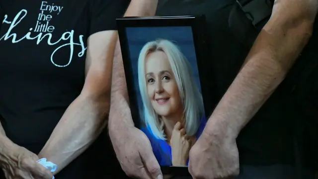 epa11491498 A person carries a photo of Ukrainian former MP Iryna Farion during her funeral procession in Lviv, Ukraine, 22 July 2024. Linguist and nationalist politician Iryna Farion died in hospital on the evening of 19 July after an unknown person shot her earlier that day near her house in Lviv, the National Police said. According to Ukrainian President Volodymyr Zelensky, the National Police of Ukraine and the Security Service of Ukraine have been deployed to search for the shooter as the investigation into her murder was ongoing. EPA/MYKOLA TYS