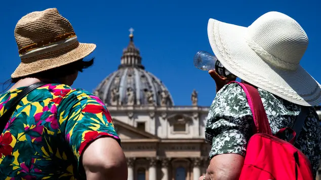 Turisti si riparano dal caldo in piazza San Pietro, Roma, 30 giugno 2024. ANSA/ANGELO CARCONI
