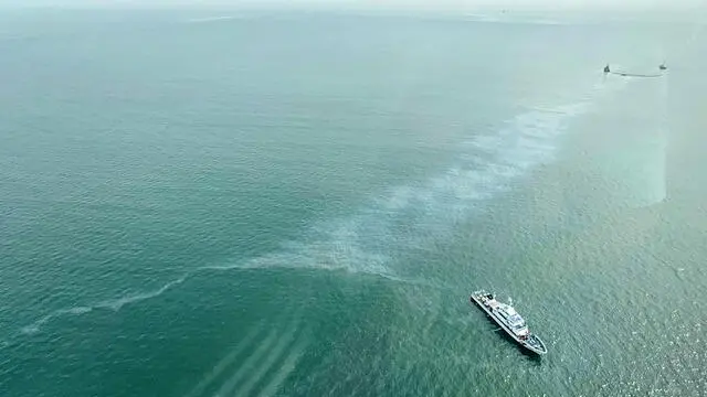 epa11498539 A handout photo made available by the Presidential Communications Office (PCO) taken through the window of a helicopter during an aerial inspection flight attended by President Ferdinand Marcos (unseen) shows Coastguard ships with an oil spill boom trying to contain an oil spill during salvage operations at the position of a sunken oil tanker off the Manila Bay, Philippines, 27 July 2024. The Philippines raced to prevent an environmental catastrophe in the Manila Bay, as the Coastguard reported an oil slick that appeared where the oil tanker 'MT Terra Nova' carrying 1.4 million liters of industrial fuel oil sank 25 July. Local authorities imposed a temporary fishing ban in Limay town, impacting thousands of fishermenâ€™s livelihoods. EPA/PRESIDENTIAL COMMUNICATIONS OFFICE HANDOUT HANDOUT EDITORIAL USE ONLY/NO SALES