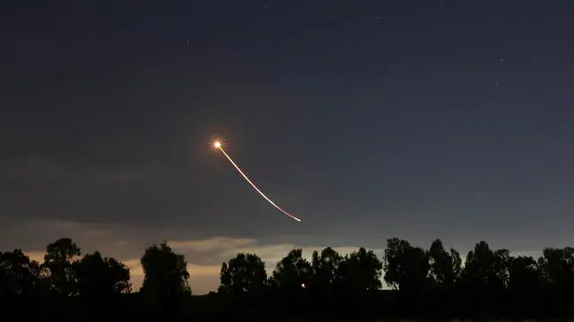 epa09198098 The trail of a rocket fired by the Israeli 'Iron Dome' anti-rocket defense system is seen in the air as it intercepts rockets fired from Gaza Strip, near the city of Sderot, Israel, 13 May 2021. Clashes erupted over the forced eviction of six Palestinian families from their homes in Sheikh Jarrah neighborhood in favor of Jewish families who claimed they used to live in the houses before fleeing in the 1948 war that led to the creation of Israel. In response to days of violent confrontations between Israeli security forces and Palestinians in Jerusalem, various Palestinian militants factions in Gaza launched rocket attacks since 10 May that killed at least six Israelis to date. The Gaza Strip's health ministry said that at least 65 Palestinians, including 13 children, were killed in the recent retaliatory Israeli airstrikes. Hamas confirmed the death of Bassem Issa, its Gaza City commander, during an airstrike. EPA/ATEF SAFADI