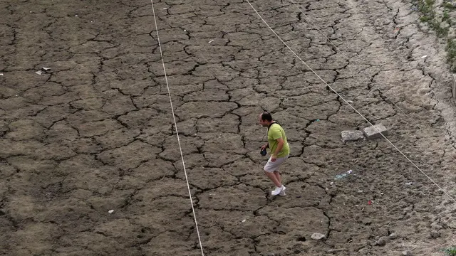 epa11504839 A man walks over the dried up patches on the banks of the Jhelum River in Srinagar, Kashmir, India, 29 July 2024. Kashmir is amidst an intense heatwave and a continued dry spell, leaving the water bodies in the region including the Jhelum River, considered the lifeline of Kashmir, depleted and with intermittent dry patches, forcing some houseboat owners to anchor their boats on its banks. According to the local Meteorological Department, 27 July 2024 at night, at 24.6 degrees Celsius was the hottest night in Srinagar in 132 years while the maximum temperature of 36.2 degrees Celsius recorded on 28 July 2024 was the fourth hottest July day in Srinagar's history. The ongoing heatwave and continued dry spell are affecting the agricultural and horticultural season while the power supply generated from hydropower plants has also declined drastically due to the low water discharge. The people in many parts of Kashmir including the Charar-e-Sharief shrine of Sufi saint Sheikh Nooruddin Noorani in central Kashmir's Budgam district also offered Salat-ul-Istiqlal prayers and held traditional dance and songs calling for an end to the ongoing dry spell. EPA/FAROOQ KHAN