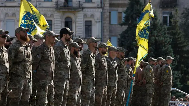 epa11503767 Servicemen of the Azov battalion attend a ceremony to remember the victims of the Olenivka camp explosion, on the Independence Square in Kyiv, 28 July 2024, amid the Russian invasion. On 29 July 2022 a building housing Ukrainian prisoners of war in Olenivka, eastern Ukraine, was destroyed, killing more than 50 people. According to Ukraine, the majority of the prisoners were soldiers from the Azovstal complex of Mariupol. Ukraine and Russia accused each other of being behind the attack. EPA/SERGEY DOLZHENKO