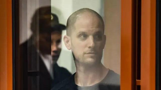 epa11487413 The Wall Street Journal (WSJ) correspondent Evan Gershkovich stands inside a glass defendant's cage during verdict announcement in the case against him, in Yekaterinburg's Sverdlovsk Regional Court, Russia, 19 July 2024. Evan Gershkovich, a US journalist of The Wall Street Journal covering Russia, was detained in Yekaterinburg on 29 March 2023. The Russian Federal Security Service (FSB) claimed that on the instructions of the American authorities, the journalist collected information constituting a state secret about one of the enterprises of the Russian military-industrial complex. Yekaterinburg's Sverdlovsk Regional Court sentenced Evan Gershkovich to 16 years in prison. EPA/STRINGER