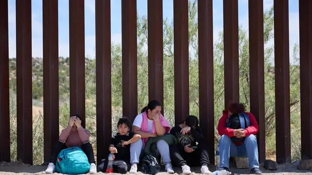 epaselect epa11390319 Migrants wait for US Border Patrol after crossing the US Mexico border in Jacumba, California, USA, 04 June 2024. Today, US President Joe Biden signed an executive order tightening restrictions on migrants seeking asylum at the US Mexico border. The order is expected to go into effect immediately. EPA/ALLISON DINNER