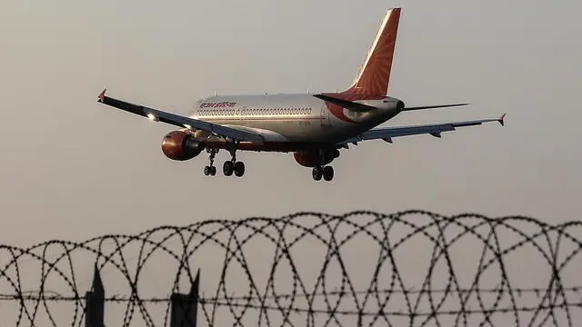 epa09712520 An Air India passenger plane flies over the Chhatrapati Shivaji International Airport in Mumbai, India, 27 January 2022. Talace Private Limited, a subsidiary of the Tata Group's, on 27 January initiated the process to take over the Air India and put Tata Group’s nominees on a new board of directors of the airline. Tata Sons chairman N. Chandrasekaran and Indian Prime Minister Narendra Modi held meeting in New Delhi earlier in the day. EPA/DIVYAKANT SOLANKI