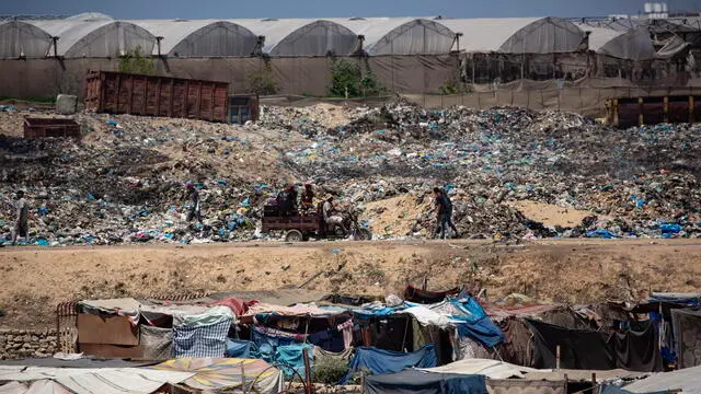epa11515454 Displaced Palestinians set up their tents next to sewage and a garbage dump on a street in Khan Younis camp in the southern Gaza Strip, 01 August 2024. Since 07 October 2023, up to 1.7 million people, or more than 75 percent of the population, have been displaced throughout the Gaza Strip, some more than once, in search of safety, according to the United Nations Relief and Works Agency for Palestine Refugees in the Near East (UNRWA), which added that the Palestinian enclave is 'on the brink of famine', with 1.1 million people (half of its population) 'experiencing catastrophic food insecurity' due to the conflict and restrictions on humanitarian access. EPA/HAITHAM IMAD