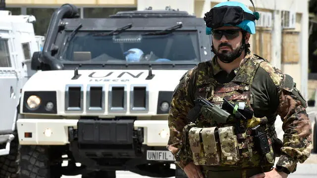 epa11459111 A UNIFIL solider stands guard during a medical day for displaced families, who fled their homes located on the Lebanese-Israeli border, at the Union of Tyre Municipalities in the southern port city of Tyre, Lebanon, 05 July 2024. United Nations Interim Force in Lebanon (UNIFIL) troops from Italy and Ghana conducted a medical day for displaced Lebanese, under the slogan 'Day of Solidarity and Health Assistance', who fled their southern Lebanese border villages to the port city of Tyre and distributed medicine, toys and goods. EPA/WAEL HAMZEH