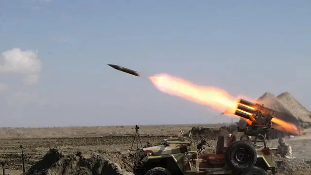 epa10383635 A handout photo made available by the Iranian Army Office shows Iranian Army troops fire a missile during a military drill in Makran beach, Gulf of Oman, near the Strait of Hormuz, southern of Iran, 31 December 2022. EPA/IRANIAN ARMY OFFICE HANDOUT HANDOUT EDITORIAL USE ONLY/NO SALES