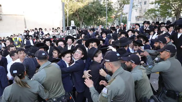 epa11272810 Police push back Ultra Orthodox Jews during a protest against army recruitment outside the military recruitment office in Jerusalem, 11 April 2024. Israel's Supreme Court gave the government an 01 April deadline to present a plan to withdraw military service exemption for ultra-Orthodox Jews studying full time in religious seminaries. After the government on 28 March asked for a 30-day extension, the Supreme Court issued an interim order to stop government funding for religious students starting 01 April. EPA/ABIR SULTAN