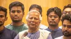 epa11537708 Nobel laureate Muhammad Yunus (C), surrounded by quota protests student leaders, speaks to the media after arriving in Dhaka at Hazrat Shahjalal International Airport, in Dhaka, Bangladesh, 08 August 2024. Yunus was sworn in as the head of Bangladesh's interim government on 08 August after former prime minister Sheikh Hasina had resigned and fled the country amid violent protests over the government's job quota system. EPA/MONIRUL ALAM