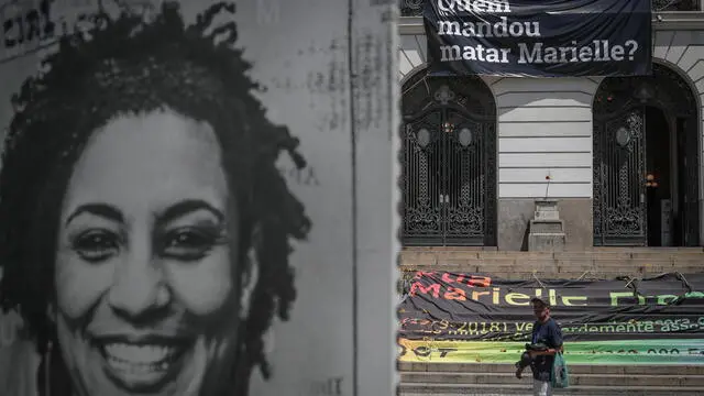 epa09824577 A person walks through the place where an act is performed to mark the four years anniversary since the assassination of the Brazilian councilor and human rights activist Marielle Franco, organized by Amnesty International, in Rio de Janeiro, Brazil, 14 March 2022. Marielle Franco, black, homosexual, from a favela in Rio de Janeiro and who stood out for her energetic action in defense of minorities, was shot dead on March 14, 2018 along with the driver of her vehicle Anderson Gomes, after participating in a political meeting in the city center. EPA/Andre Coelho