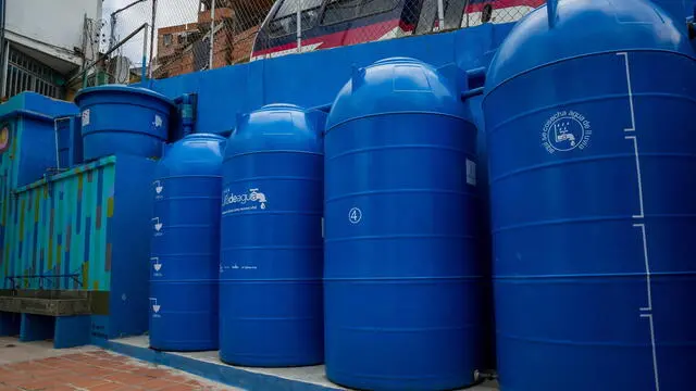 epa09520338 Rainwater tanks and filters at the entrance of a school, on 10 October 2021, in Caracas, Venezuela (issued 12 October 2021). The children of two schools in Petare, the largest neighborhood in Venezuela, attended classes with a bucket of water due to the constant failures of the service in the sector, but with the capture and treatment of water resources from the rains, promoted by the Lata de Agua social project, the liquid comes out of the taps again. The initiative is developed by the architects Ana Babic and Laurencio Sanchez from their company Arqbiental, in alliance with the Rayo de Luz foundation, with which they were able to install their pilot test in these two schools and an outpatient clinic. EPA/Miguel Gutierrez