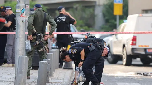 epa11486766 Police inspect the damage at the scene of an explosion possibly caused by an unmanned aerial vehicle (UAV), in Tel Aviv, Israel, 19 July 2024. According to a statement by the Israeli Defense Forces (IDF), one person was killed and eight others injured in the explosion, which was caused by 'a falling aerial target.' The explosion occured around 50 meters (164 feet) from the US Embassy in Tel Aviv. EPA/ABIR SULTAN