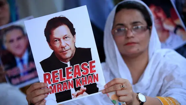 epa11494389 A supporter of the Pakistan Tehreek-e-Insaf (PTI) party holds a portrait of party founder and convicted former prime minister Imran Khan during a hunger strike camp to demand the release of Imran Khan and his wife Bushra Bibi, in Peshawar, Pakistan, 24 July 2024. PTI lawmakers in the national assembly (lower house of the parliament), led by Opposition Leader Omar Ayub, have also launched a hunger strike camp outside the Parliament, to demand the release of party founder Imran Khan, and protest against the arrests of the party's social media activists, and address rising inflation. EPA/BILAWAL ARBAB