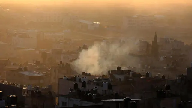 epa10981927 Smoke rises over Balata Refuge Camp during an Israeli raid on the camp, near Nablus, the West Bank, 18 November 2023. According to the Palestinian Red Crescent, five people were killed and two injured in an Israeli strike on a building in the West Bank's Balata refugee camp near Nablus. The camp's administration said an aerial strike targeted the local headquarters of the Palestinian group Fatah. EPA/ALAA BADARNEH