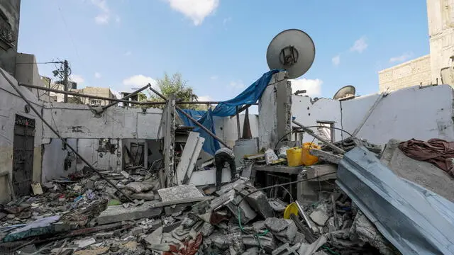 epa11548253 A Palestinian inspects a destroyed house following an Israeli air strike in Al Maghazi refugee camp, Gaza Strip, 14 August 2024. The Palestinian Health Ministry in Gaza said at least six Palestinians were killed from the Eid family in the Israeli strike in the Al Maghazi refugee camp and more than 10 others were injured. More than 39,500 Palestinians and over 1,400 Israelis have been killed, according to the Palestinian Health Ministry and the Israel Defense Forces (IDF), since Hamas militants launched an attack against Israel from the Gaza Strip on 07 October 2023, and the Israeli operations in Gaza and the West Bank which followed it. EPA/MOHAMMED SABER