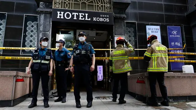 epa11560892 South Korean police offcials stand guard front of the site of a fire at a hotel in Bucheon, around 25 km west of Seoul, South Korea, 23 August 2024. According to a statement from the South Korean Ministry of Interior, seven people were killed in the fire, and 12 others were injured. Authorities stated that the fire began in a room on the eighth floor of the nine-story hotel at 7:39 p.m on 22 August. EPA/JEON HEON-KYUN