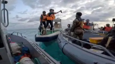 epa11424214 A handout photo made available by the Armed Forces of the Philippines (AFP) shows a Chinese Coast Guard personnel with an axe during a Philippine rotation and resupply mission to the Second Thomas Shoal (Ayungin Shoal) in disputed waters of the South China Sea on 17 June 2024 (issued 20 June 2024). A statement from AFP Chief-of-Staff, Gen. Romeo Brawner Jr., said that 'The Chinese Coast Guard has no right or legal authority to interfere with our legitimate operations or damage our assets within our Exclusive Economic Zone (EEZ). This reckless and aggressive behavior has caused bodily harm and constitutes a blatant violation of international maritime law, Philippine sovereignty, and sovereign rights.' EPA/ARMED FORCES OF THE PHILIPPINES/HANDOUT BEST QUALITY AVAILABLE HANDOUT EDITORIAL USE ONLY/NO SALES HANDOUT EDITORIAL USE ONLY/NO SALES