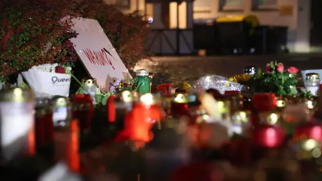 epa11563674 Flowers and candles are placed near the scene of knife attack, in Solingen, Germany, 24 August 2024. A man stabbed passers-by at random with a knife during the city festival in Solingen late 23 August. Three people have been killed and eight others injured, five of them seriously, in the knife attack, police said. Police are currently conducting a large-scale search for the perpetrator. EPA/CHRISTOPHER NEUNDORF