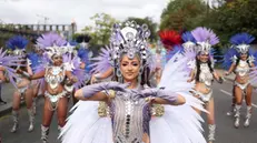 epa10825358 Performers in costumes take part in the Notting Hill Carnival in London, Britain, 28 August 2023. Notting Hill is the largest street carnival in Europe and a community-led celebration of Caribbean history and culture, this year running from 27 to 28 August. EPA/NEIL HALL