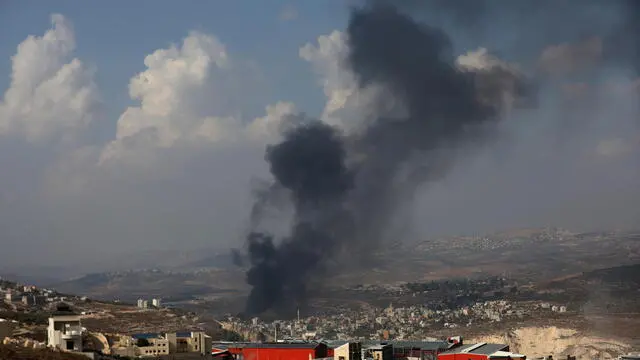 epa10954295 Smoke rises above the town of Deir Sharaf after Israeli settlers attacked the village and set Palestinan cars and shops on fire, near the West Bank city of Nablus, 02 November 2023. The Palestinian ministry puts the death toll of Palestinians in the West Bank at more than 120 Palestinian people and over 2,000 injured between 07 and 30 October, following the escalation of hostilities between Israel and Hamas. EPA/ALAA BADARNEH