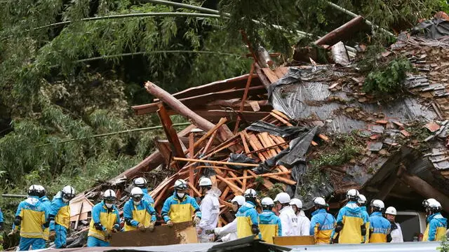 epa11568340 Rescue workers search for missing residents amid the ruins of a house collapsed due to heavy rain triggered by typhoon Shanshan in Gamagori, Aichi Prefecture, central Japan, 28 August 2024. Two of the five-member family buried by the landslide were rescued. The Japan Meteorological Agency on 28 August issued a special warning for strong winds, high waves, high tides and heavy rain for southwestern Japan as typhoon Shanshan is approaching Kagoshima Prefecture. The typhoon is expected to make landfall on southern Kyushu toward 29 August, the agency said. Japan's Shinkansen bullet train services are expected to be suspended from late 28 August, while airlines have already announced to cancel about 200 flights on 28 and 29 August. EPA/JIJI PRESS JAPAN OUT EDITORIAL USE ONLY