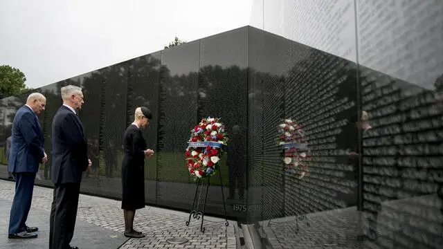 epa06989825 Cindy McCain, wife of, Sen. John McCain, R-Ariz., accompanied by President Donald Trump's Chief of Staff John Kelly (L), and Defense Secretary Jim Mattis (2-L) lays a wreath at the Vietnam Veterans Memorial in Washington, USA, 01 September 2018, during a funeral procession to carry the casket of her husband from the US Capitol to National Cathedral for a Memorial Service. McCain died 25 August 2018 from brain cancer at his ranch in Sedona, Arizona, USA. He was a veteran of the Vietnam War, served two terms in the US House of Representatives, and was elected to five terms in the US Senate. McCain also ran for president twice, and was the Republican nominee in 2008. EPA/ANDREW HARNIK / POOL