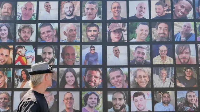 epa11581357 A man looks at a billboard showing pictures of Israeli hostages held by Hamas in Gaza in Jerusalem, 03 September 2024. Israel's largest labor union, Histadrut, called for a nationwide general strike to start on 02 September urging the Israeli Prime Minister to reach a deal to secure the remaining hostages held by Hamas following the 07 October attack. Thousands of Israelis protested across Israel on 01 September following the recovery of the bodies of six hostagres held by Hamas in the Gaza Strip. According to a statement by the Israeli Government Press Office, 97 Israeli hostages remain in captivity in the Gaza Strip, with 33 confirmed dead. EPA/ABIR SULTAN