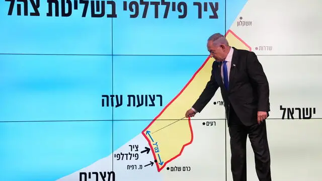 epa11580671 Israeli Prime Minister Benjamin Netanyahu points at a map of the Gaza Strip during a news conference in Jerusalem, 02 September 2024. The Israeli Prime Minister said, among other things, that Israel 'must have control' over Philadelphi Corridor, a narrow strip of land along the border between the Gaza Strip and Egypt. The words in Hebrew on screen read, 'Philadelphi corridor under Israeli military control.' EPA/OHAD ZWIGENBERG / POOL