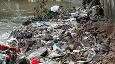 epa11581218 A resident walks along a damaged creek side area in a flood-affected village in Antipolo, Rizal province, about 40 kilometers east of Manila, Philippines, 03 September 2024. According to a 03 September report by the National Disaster Risk Reduction and Management Council (NDRRMC), ten people have died, ten have been injured, and thousands of residents left their homes due to flooding in the wake of Typhoon Yagi. EPA/ROLEX DELA PENA