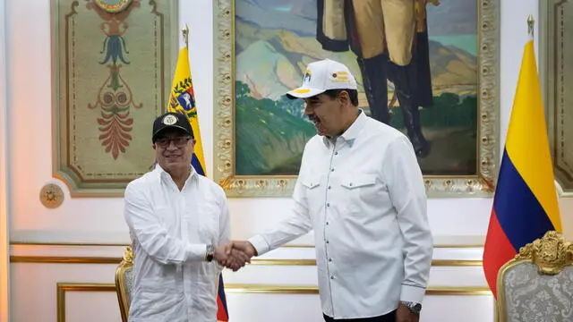 epa11268481 Colombian President Gustavo Petro (L) shakes hands with Venezuelan counterpart Nicolas Maduro (R) during a meeting at the Miraflores Palace, in Caracas, Venezuela, on 09 April 2024. The meeting was cordially held despite the recent criticism by Petro on the elections process in Venezuela, where the principal opposition leader has been unable to register. EPA/Rayner Pena R.