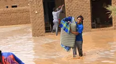 epa11567852 People salvage their belongings at a flood-affected area, in Masawi, the northern state of Merowe, Sudan, 27 August 2024. According to the United Nations Office for the Coordination of Humanitarian Affairs (OCHA) in Sudan, at least 30 people have died after the Arba'at Dam, located approximately 38 km northwest of Port Sudan in Sudan's Red Sea State, was extensively damaged on 25 August due to heavy rains. Some 50,000 people living on the western side of the Dam have been severely affected, according to local authorities. OCHA figures state the floods affecting Sudan since July 2024 had already displaced at least 118,000 people prior to the dam collapse, and 317,000 were already affected across 16 of the 18 Sudanese states. EPA/STR