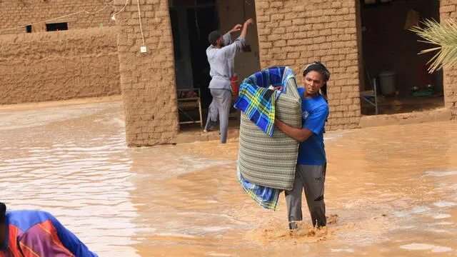 epa11567852 People salvage their belongings at a flood-affected area, in Masawi, the northern state of Merowe, Sudan, 27 August 2024. According to the United Nations Office for the Coordination of Humanitarian Affairs (OCHA) in Sudan, at least 30 people have died after the Arba'at Dam, located approximately 38 km northwest of Port Sudan in Sudan's Red Sea State, was extensively damaged on 25 August due to heavy rains. Some 50,000 people living on the western side of the Dam have been severely affected, according to local authorities. OCHA figures state the floods affecting Sudan since July 2024 had already displaced at least 118,000 people prior to the dam collapse, and 317,000 were already affected across 16 of the 18 Sudanese states. EPA/STR