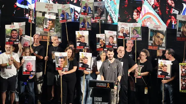 epa11591912 Rescued Israeli hostage Andrey Kozlov (front) speaks on stage during a protest calling for a ceasefire and for the release of Israeli hostages held by Hamas in Gaza, near the Kirya in Tel Aviv, Israel, 07 September 2024. According to a statement by the Israeli Government Press Office, 97 Israeli hostages remain in captivity in the Gaza Strip, including bodies of 33 confirmed dead. EPA/ABIR SULTAN